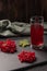 Red juice from viburnum in a glass on a dark background. Near viburnum berries, and linen cloth. Healthy food