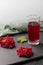 Red juice from viburnum in a glass on a light background. Near viburnum berries, and linen cloth. Healthy food