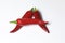 Red juicy hot pepper on white background. Lies in the form of the letter A.