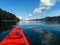 Red kayak and blue sky in the water.