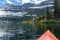 A red kayak on Cameron Lake in Waterton National Park, enjoying the glacier scenery