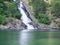 red kayak at the waterfall, nature Norway, fjord background