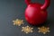 Red kettlebell on a black gym floor with three gold snowflakes