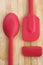 Red Kitchen Spoon and Spatulas on Wood Background