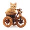 Red kitten on toy bike.