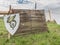 Red knights shield with family coat of arms on grass