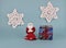 A red knitted angel stands next to a New Year\\\'s present tied with a red ribbon.