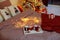 Red knitted cups of tea staying on wooden tray with Christmas lights lies on bed. Winter holiday morning, cozy room. Cups of tea f