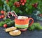 Red knitted mug with Christmas drink and cookies