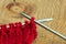 Red knitting wool, knitting needles