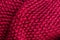 Red knitting wool texture background. Colorful knitted horizontal textured background.