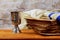 Red kosher wine with a white plate of matzah or matza and a Passover Haggadah on a vintage wood background