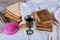 Red kosher wine with a white plate of matzah or matza and a Passover Haggadah on a vintage wood background