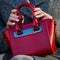 Red ladies handbag closeup. Fashion accessory