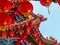 Red Lantern decoration details on a Chinese Temple roof against a blue sky