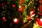 Red lanterns on a branch of a Christmas tree on a red brick wall background