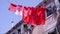 Red laundry drying on rope by old building over street road