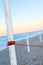 Red leash pole with Morning light stones on beach close to the s