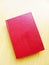 Red leather bound book on brown table top