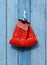 Red leather boxing gloves hang on a nail