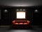 Red leather divan and bookcase in dark room