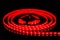 Red LED strip on reel with black background