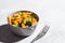 Red lentil pasta with broccoli in gray bowl. Healthy vegan pasta with vegetables