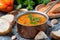 Red lentil soup with pepper and spices in a copper saucepan