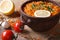 Red lentil soup with vegetables close-up on the table. horizontal