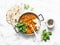 Red lentils dhal and paratha flatbread - healthy vegetarian dinner in Indian style on light background