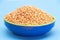 Red lentils pile or masoor dhal isolated on blue background