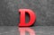 Red letter D on concrete wall an floor background series 3D render