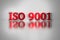 Red letters of ISO 9001 quality standard.