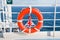 Red life buoy on side of cruise liner