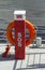 A red life preserving buoyancy aid on a floating pontoon.