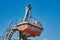 Red lifeboat hanging on a deck of vessel