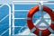 Red lifebuoy aboard a ship on the high seas, close-up