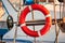 Red lifebuoy, fixed on deck of the yacht