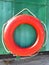 Red lifebuoy on green vintage background. Marine beach background. Summer background. Emergency help, photo