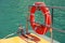 Red lifebuoy hanging on railings of rescue boat