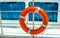 Red lifebuoy on ship railing