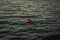 Red lifebuoy thrown overboard in the black sea