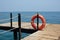 Red Lifebuoy on wooden pier