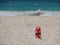 Red Lifesaver lifeguard in sand at beach