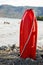 Red Lifesaver lifeguard in sand at beach.