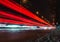 Red light trails in the illuminated highway at night