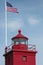 Red Lighthouse with American Flag