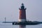 A red lighthouse in the Delaware Bay during the blue hour