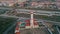 Red lighthouse drone view at seaside town. Urban infrastructure in port city.