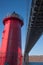 A red lighthouse and the George Washington bridge